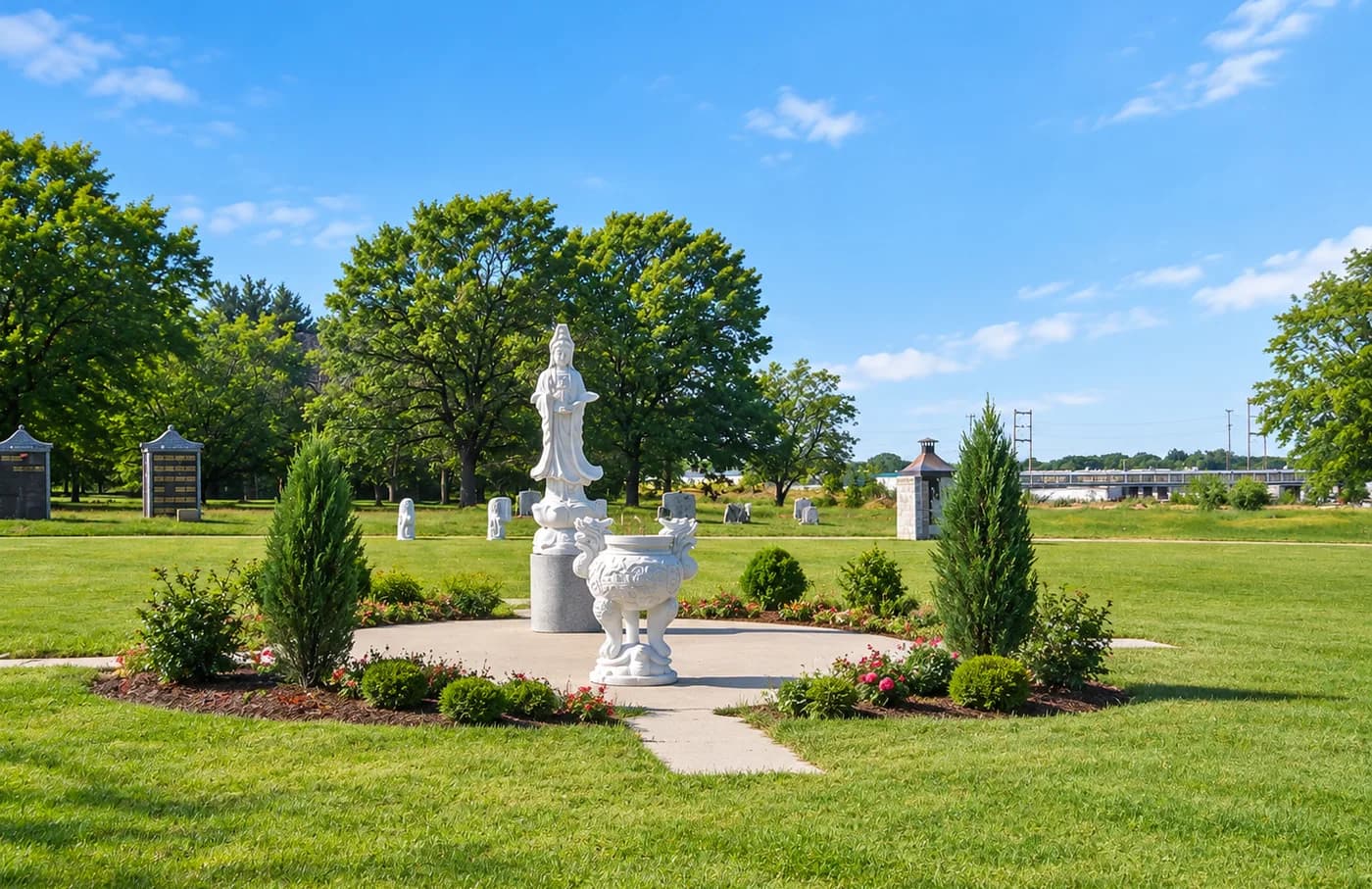 White statuary in a planted circle on the lawns of Bethel Memorial Park.