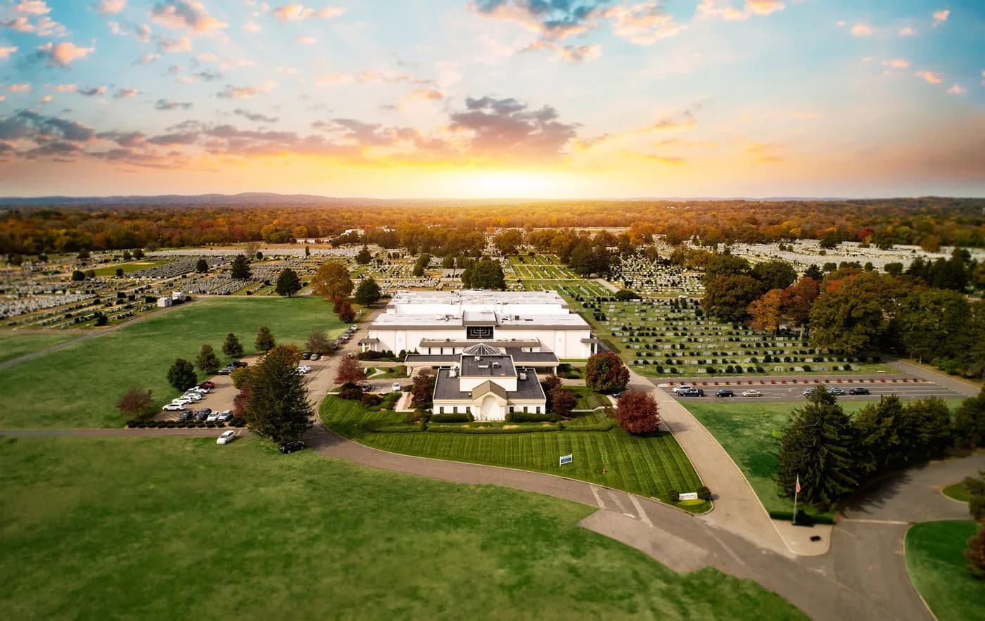 An aerial view of Cedar Park Cemetery at sunset, its buildings set among the lawns.