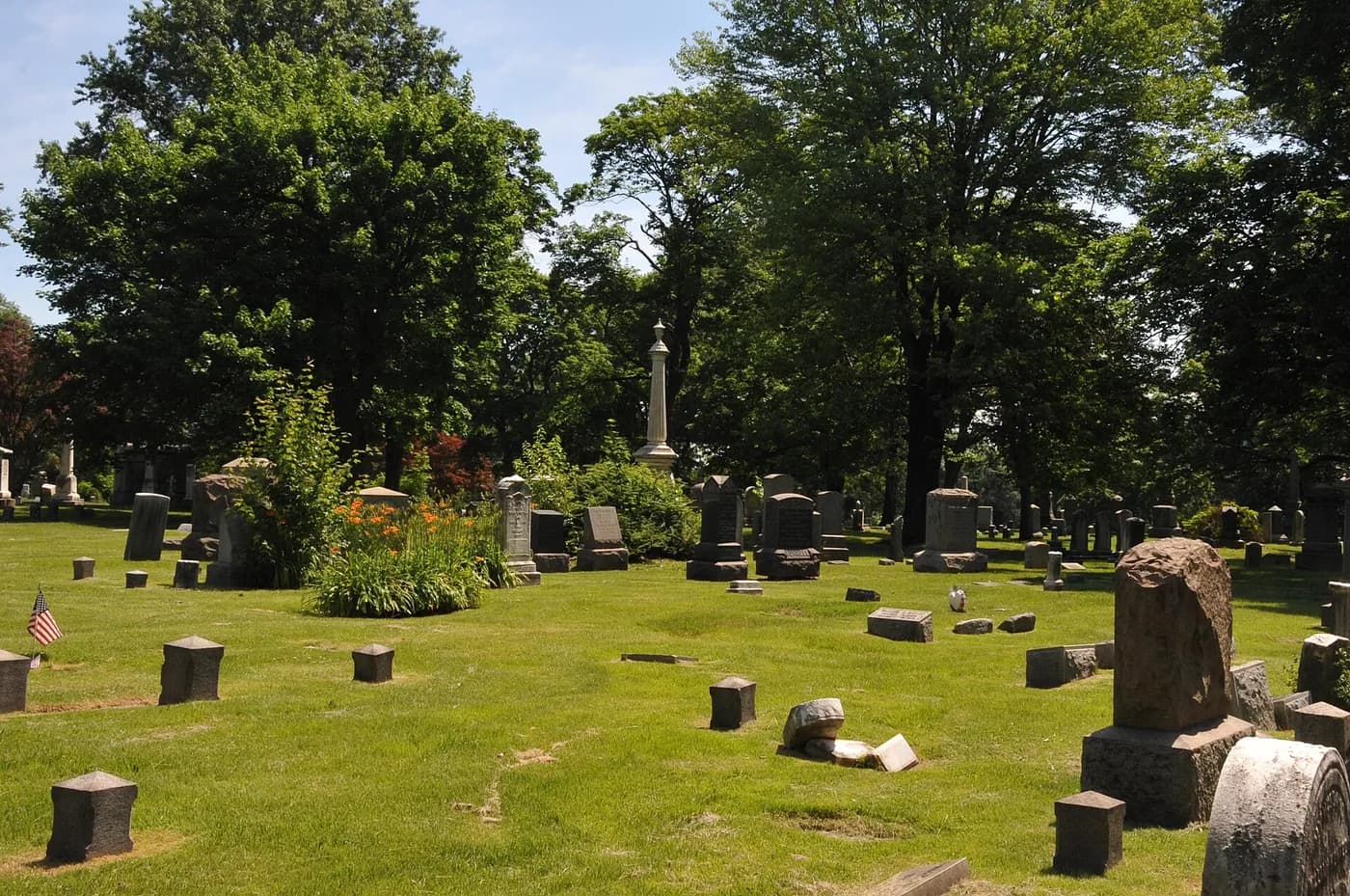 Old headstones and monuments among the trees at Evergreen Cemetery.