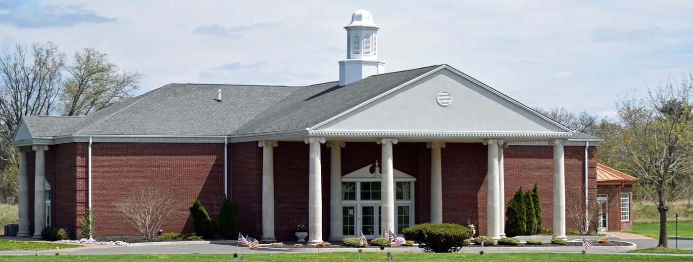 The brick building with a white portico and cupola at Lakeview Memorial Park.